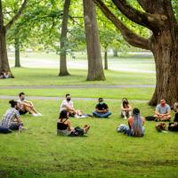 Students seated in a circle outside