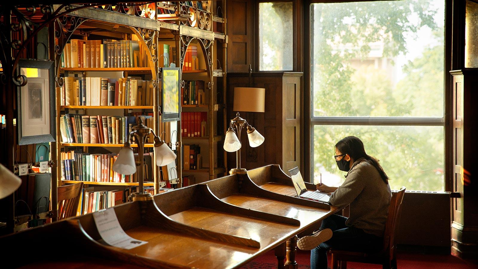 student studying in A.D. White Library