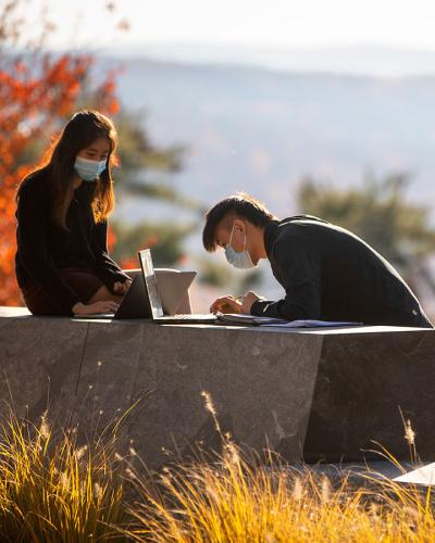 Students study on Lib Slope in the fall