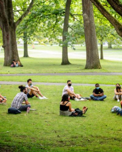 Students seated in a circle outside